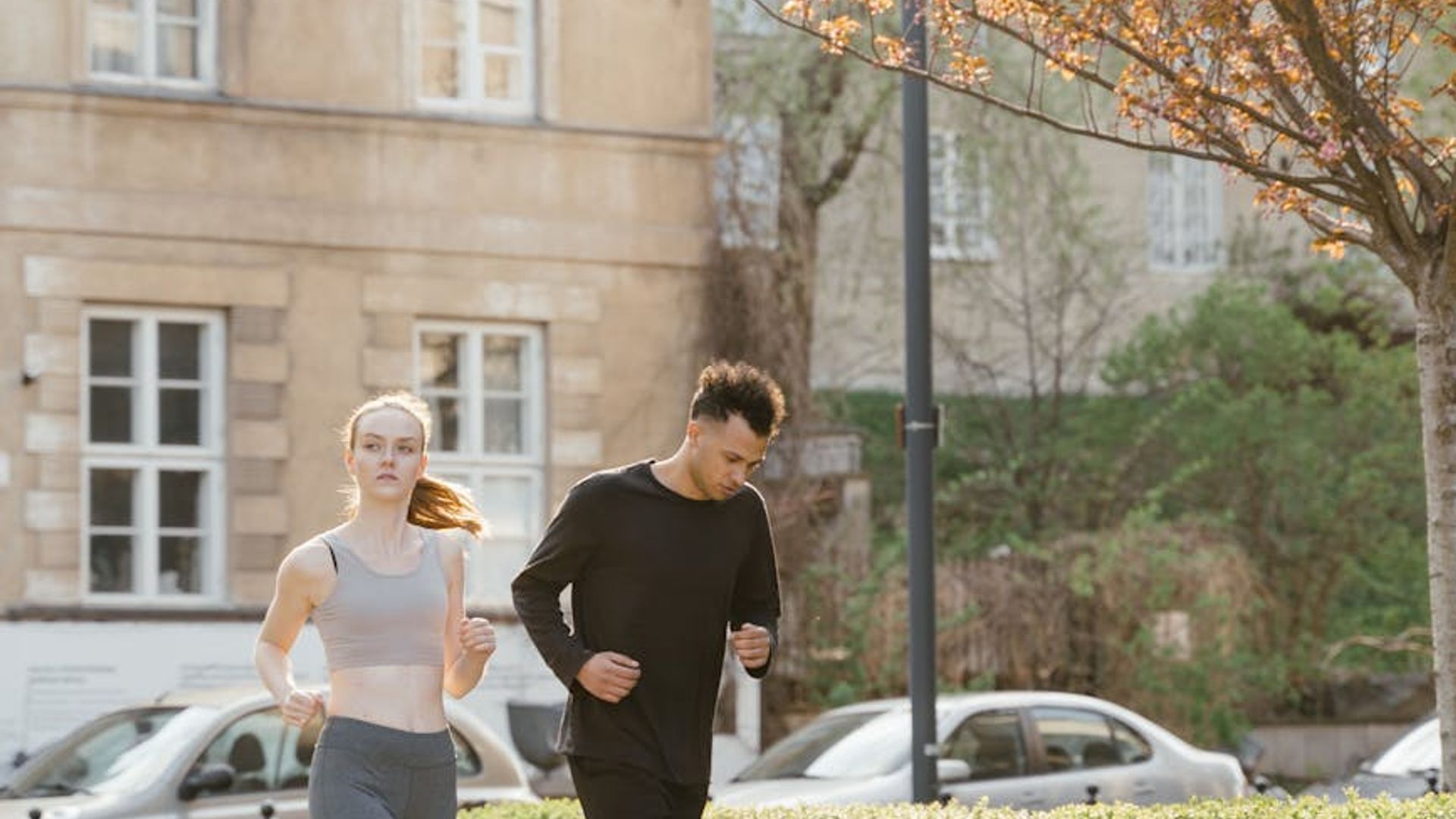 Athletic person running in a foggy urban park setting