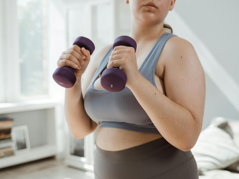 Person hands holding a water bottle after morning cardio workout